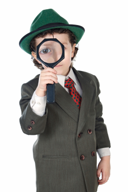 Kid in a suit with a magnifying glass